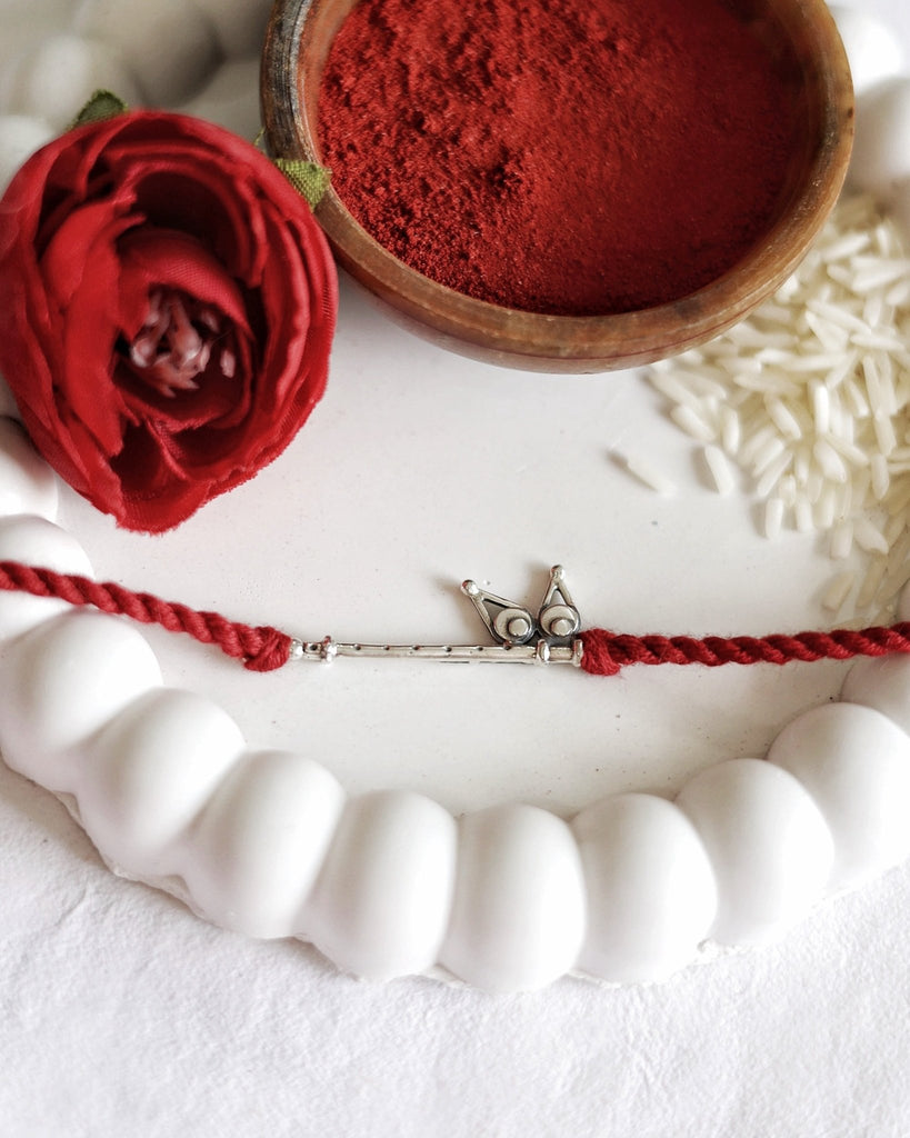 Bansuri Charm Rakhi - Smith JewelsRakhi